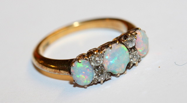 Appraisal: A THREE STONE OPAL AND DIAMOND DRESS RING three graduated