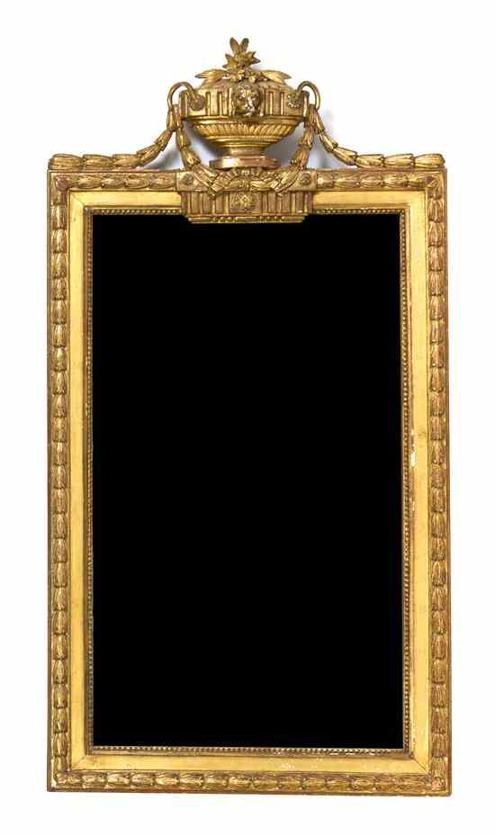 Appraisal: A Continental Giltwood Pier Mirror having a mask and foliate