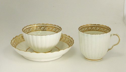 Appraisal: A Caughley fluted trio ribbed and painted gilded scrolls within