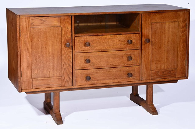 Appraisal: A COTSWOLD SCHOOL OAK SIDEBOARD in the manner of Gordon