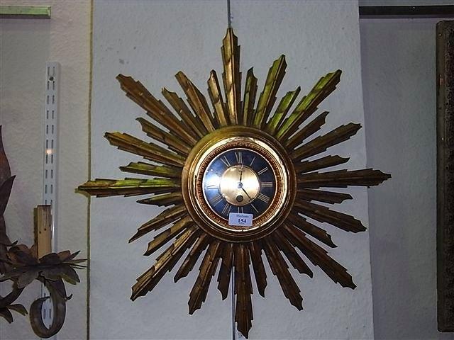 Appraisal: A GILT WORK SUNBURST WALL CLOCK with circular dial and