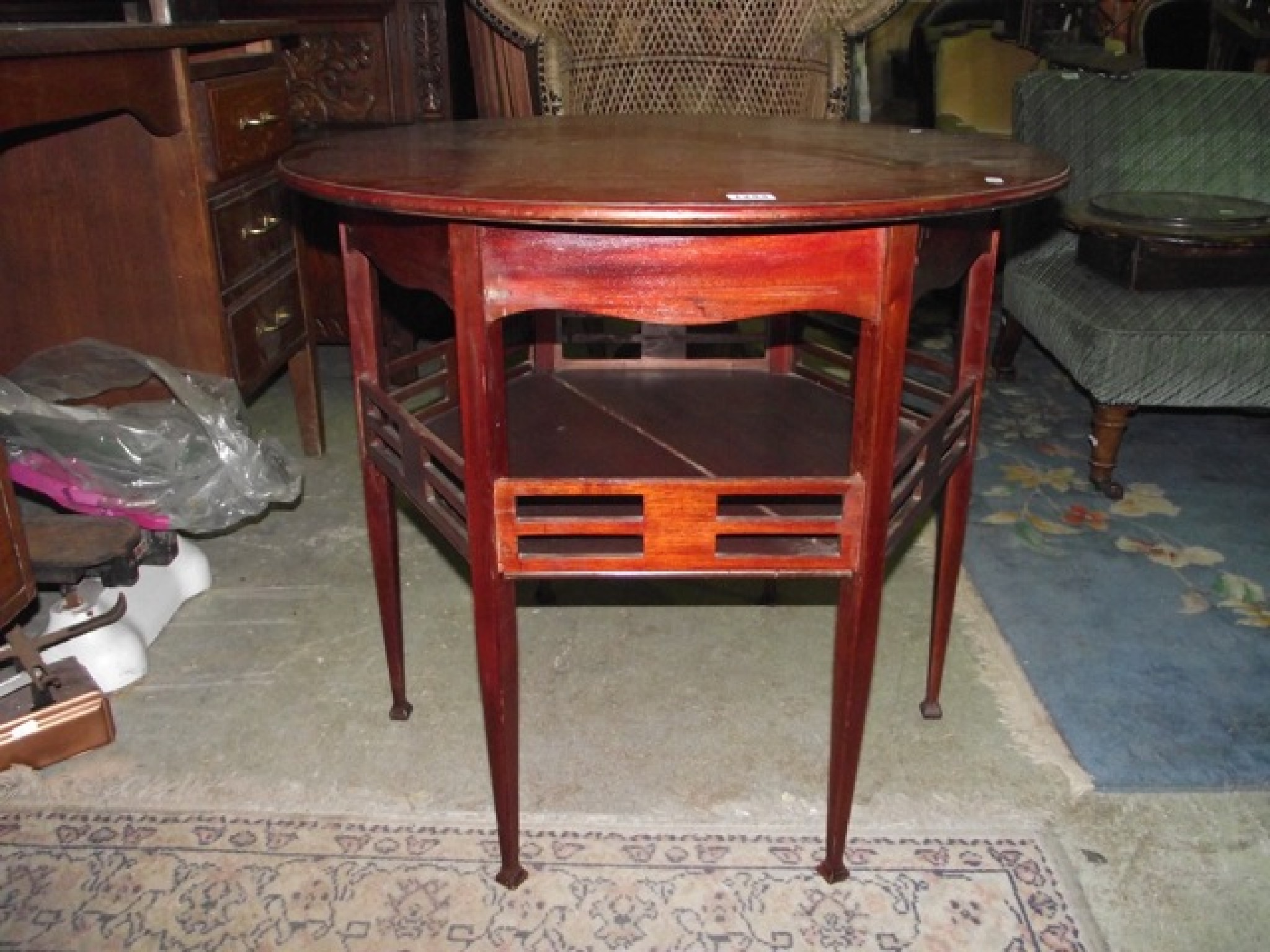 Appraisal: An Edwardian arts and crafts mahogany occasional table the circular