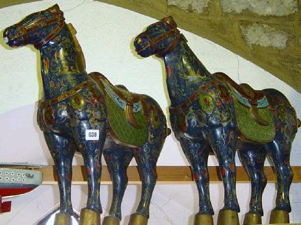 Appraisal: A pair of carved hardwood horses in the oriental fashion