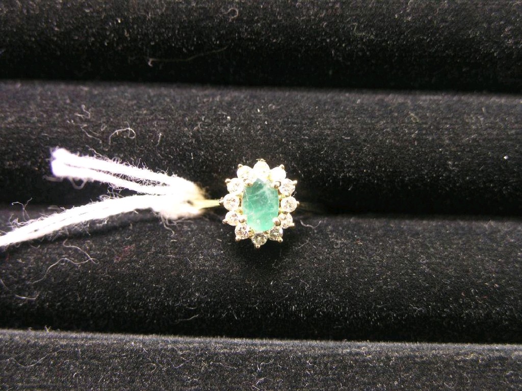 Appraisal: A modern emerald and diamond cluster ring central oval emerald