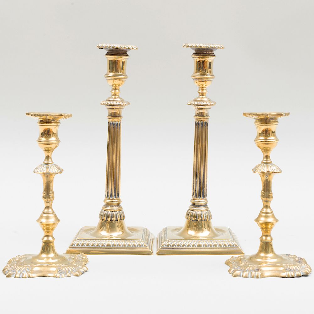 Appraisal: Two Pairs of George III Brass Candlesticks The two tall