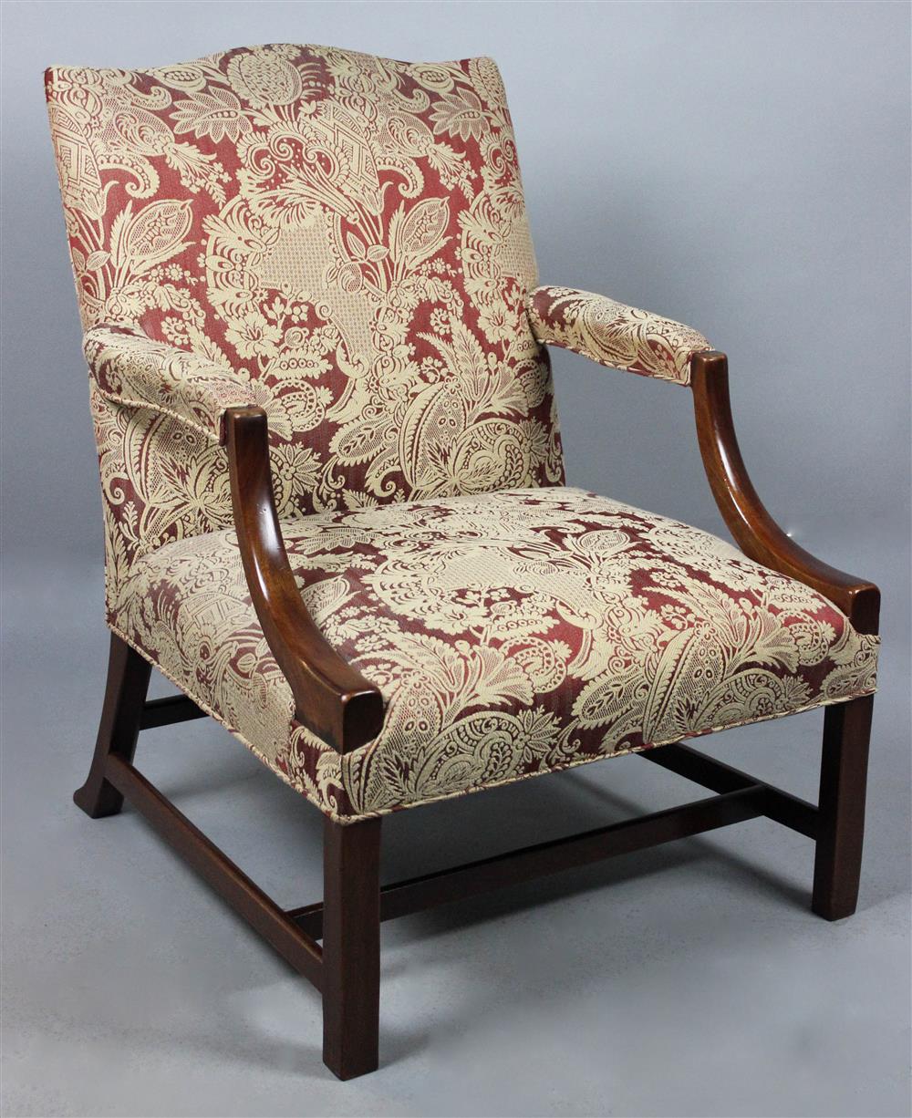 Appraisal: GEORGIAN STYLE MAHOGANY UPHOLSTERED OPEN ARM LIBRARY CHAIR shaped crest