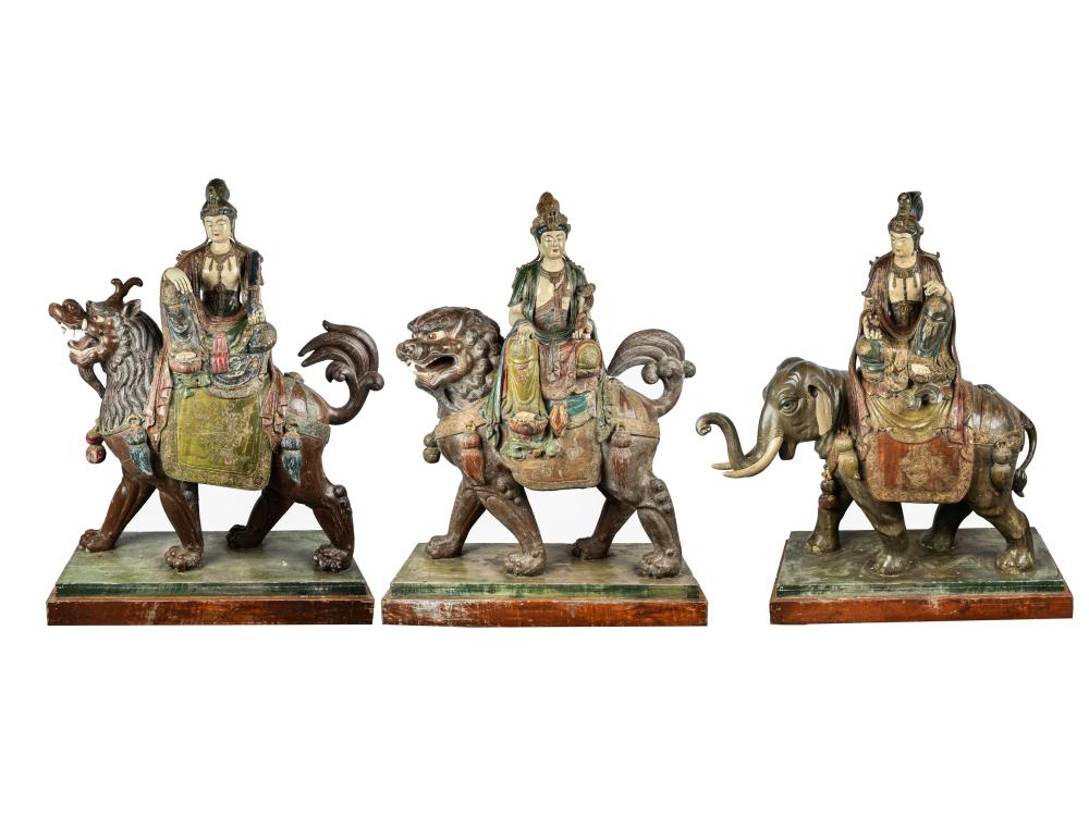 Appraisal: THREE CHINESE POLYCHROMED WOOD FIGURESeach figure set atop foo dog