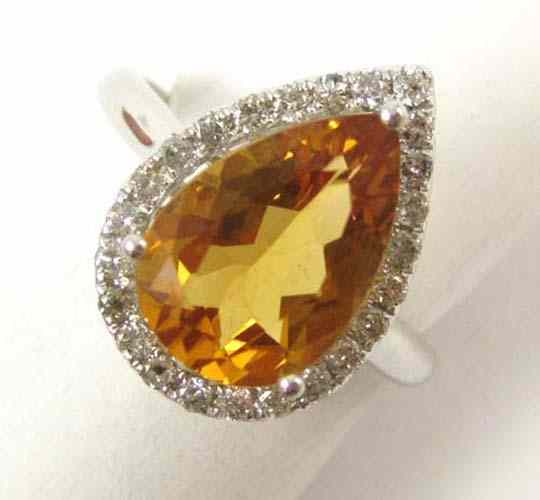 Appraisal: ORANGE TOPAZ AND DIAMOND RING k white gold with round-cut