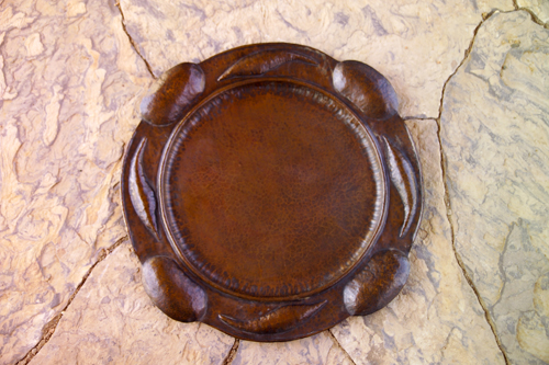 Appraisal: BENEDICT Hammered copper large circular tray embossed with pods and