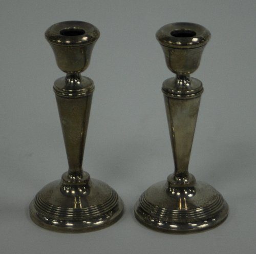 Appraisal: A pair of silver candlesticks Birmingham and with tapered columns