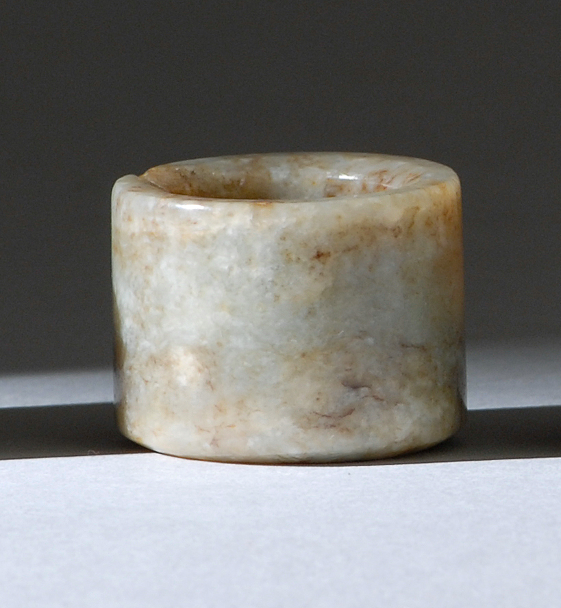 Appraisal: GRAY AND BROWN JADE ARCHER'S RING th th CenturyWith shadow-like