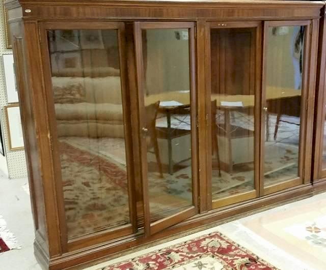 Appraisal: Large walnut bookcase A large walnut bookcase Having glass doors