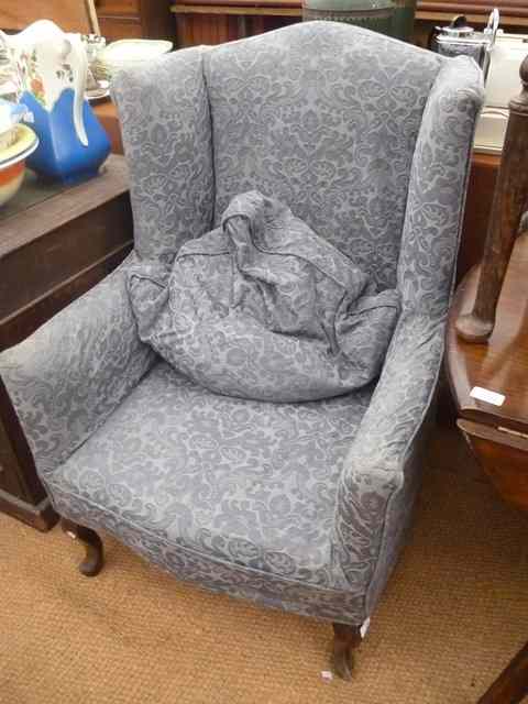 Appraisal: A GEORGIAN STYLE WING BACK BLUE UPHOLSTERED ARMCHAIR wide with