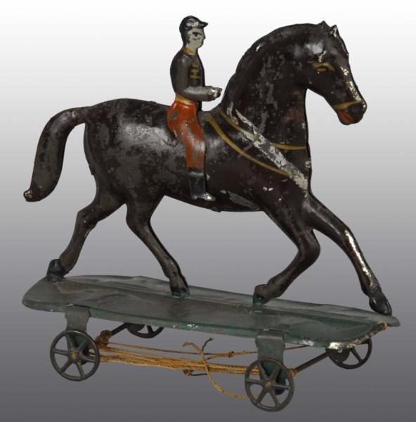 Appraisal: American Tin Horse Rider Platform Toy Description Hand-painted Cast metal