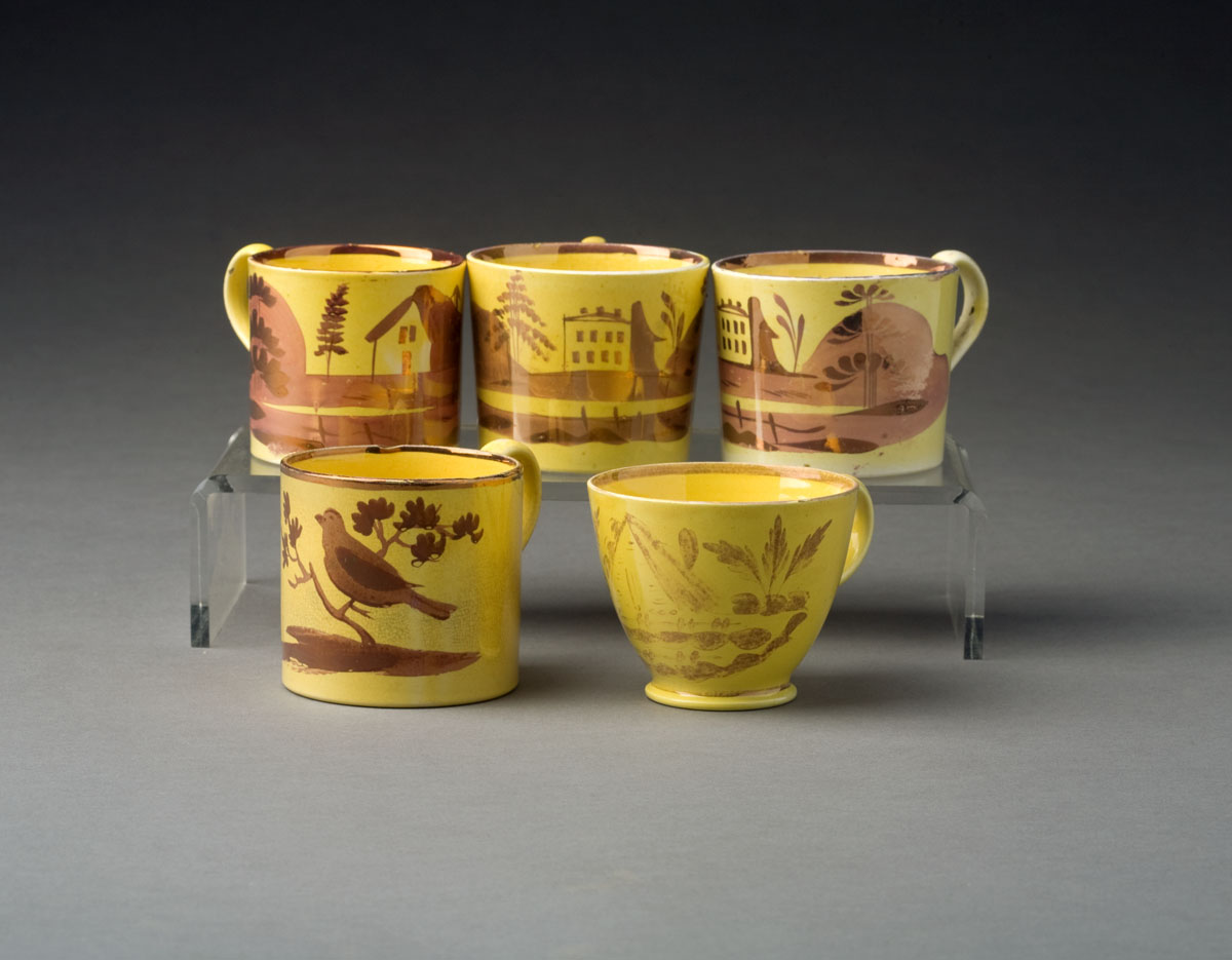 Appraisal: FOUR ENGLISH YELLOW-GLAZED PINK LUSTRE MUGS AND A TEACUP CIRCA