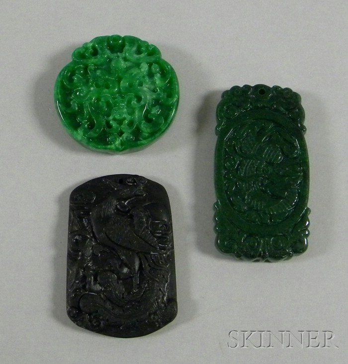 Appraisal: Three Asian Carved Stone Pendants one round green one rectangular