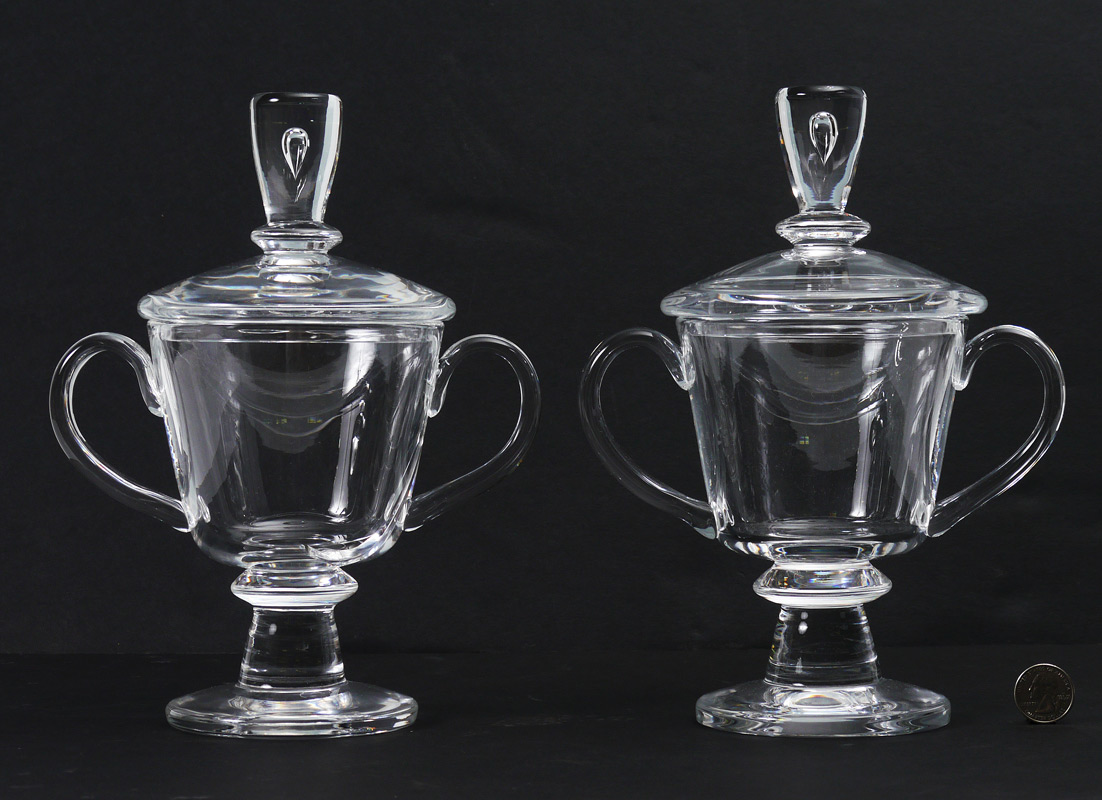 Appraisal: PAIR STEUBEN TEARDROP COVERED URNS Lid with suspended teardrop in