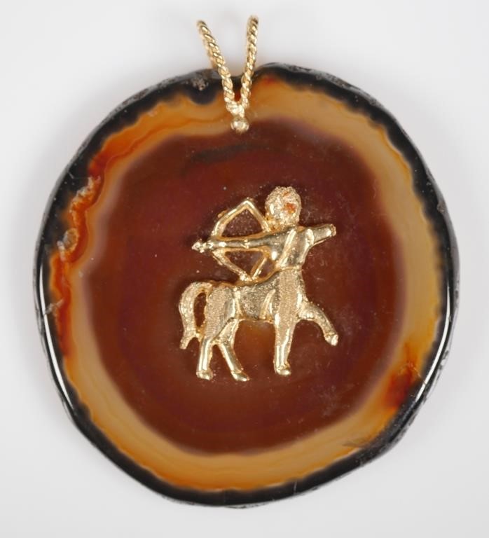 Appraisal: K GOLD SAGITTARIUS POLISHED STONE PENDANT K yellow gold Sagittarius