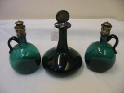 Appraisal: A PAIR OF GREEN GLASS WINE JUGS of flattened circular