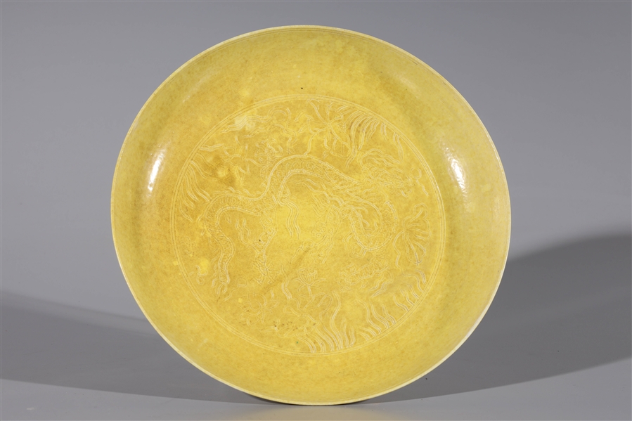 Appraisal: Chinese porcelain yellow dish with dragon design with six-character Hongzhi