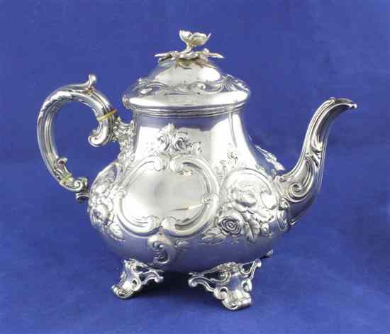 Appraisal: A Victorian silver teapot of squat baluster form with engraved