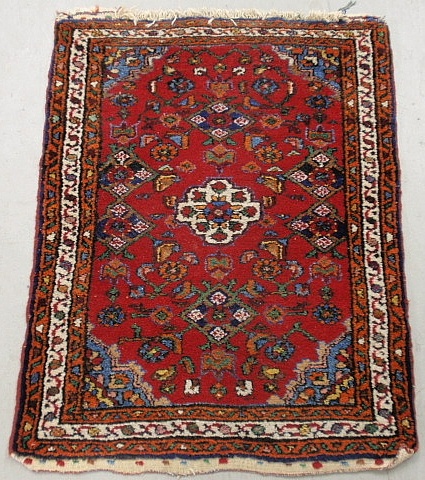 Appraisal: - Persian oriental mat with red field floral patterns and