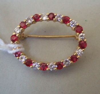 Appraisal: A gold ruby and diamond set oval brooch in an