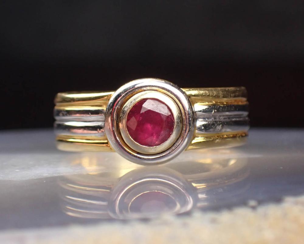 Appraisal: RUBY AND FOURTEEN KARAT TWO-TONE GOLD RING The yellow and