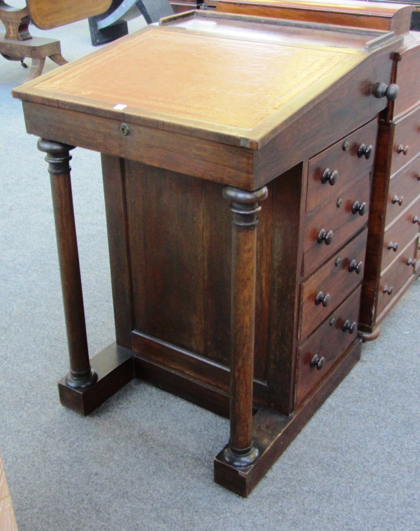 Appraisal: An early Victorian rosewood Davenport with turned columns cm wide