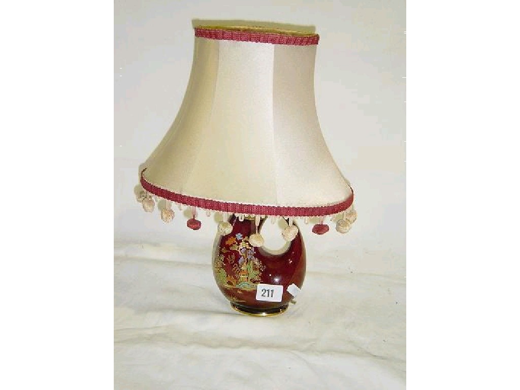 Appraisal: A Crown Devon red ground lamp base of curving horn