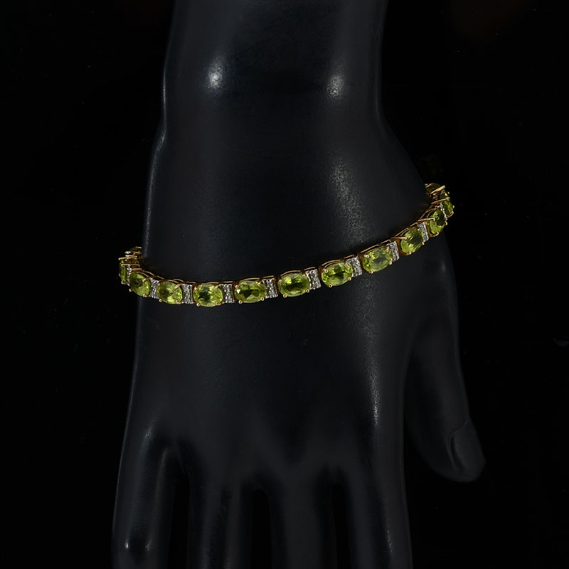 Appraisal: K PERIDOT BRACELET lovely oval cut peridot stones are offset