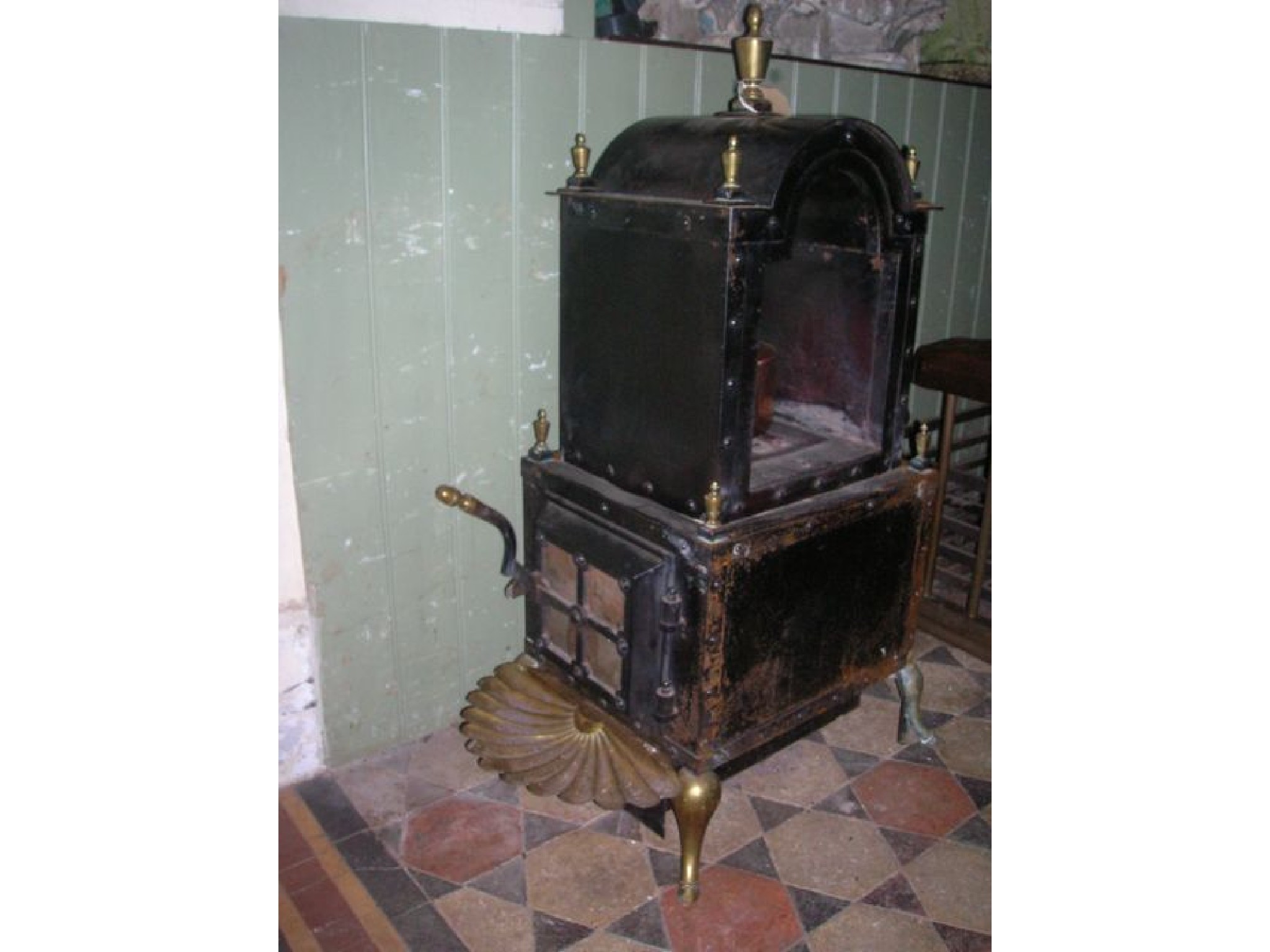 Appraisal: A floor standing stove of sheet steel construction with riveted