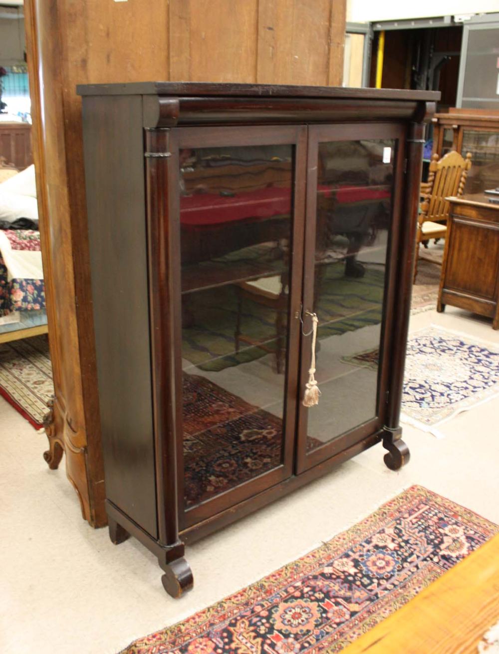 Appraisal: MAHOGANY CABINET BOOKCASE Empire Revival style American c the interior