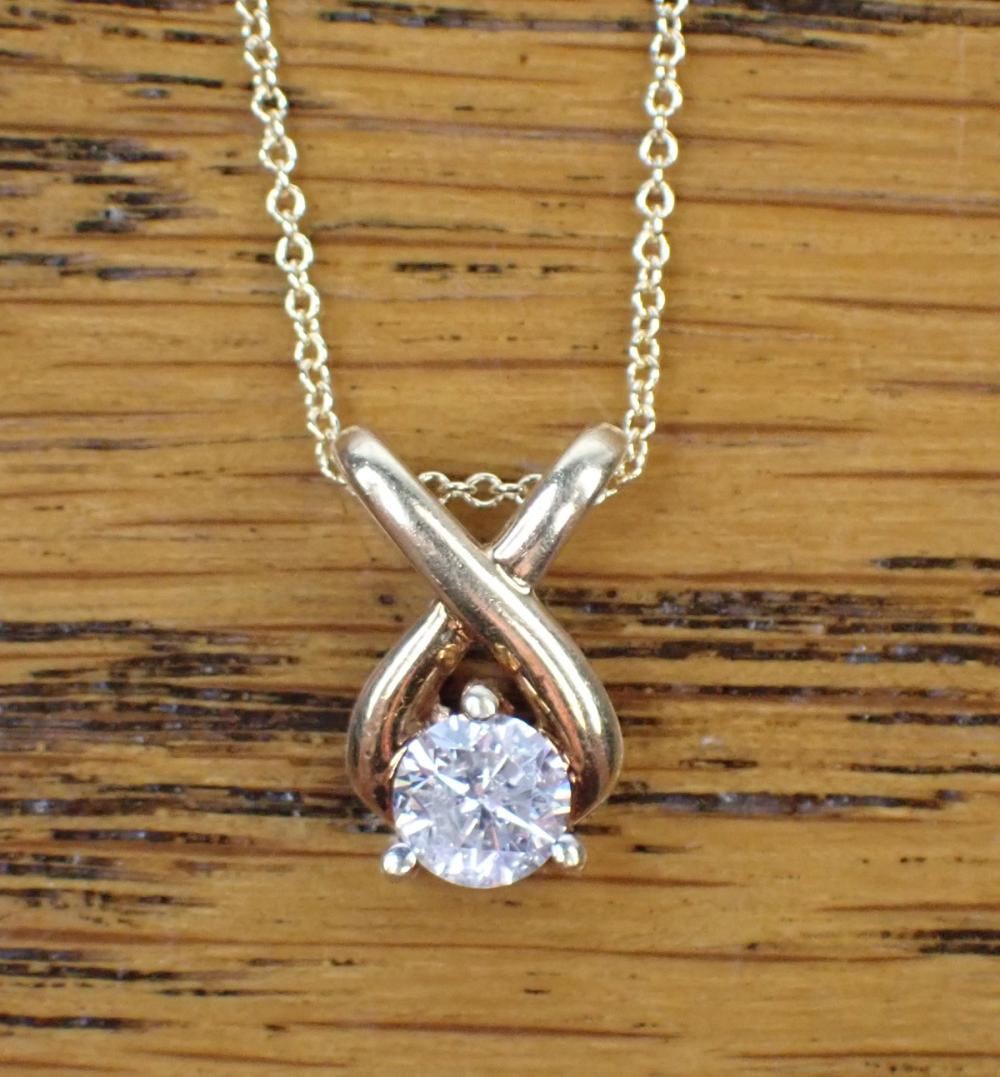 Appraisal: DIAMOND SOLITAIRE AND FOURTEEN KARAT GOLD PENDANT NECKLACE featuring a