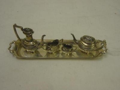 Appraisal: A MINIATURE FOUR PIECE TEA SERVICE of oval half fluted