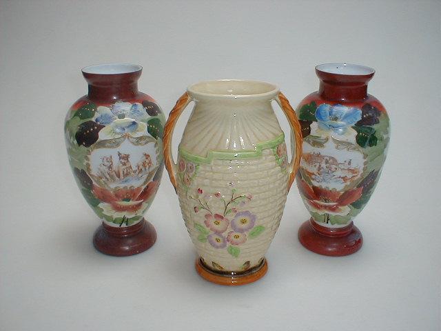 Appraisal: A pottery two handled jug moulded with garden flowers against