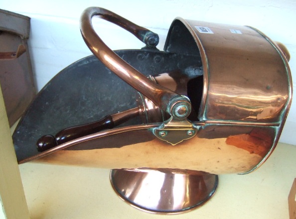 Appraisal: A helmet shaped copper coal scuttle and shovel