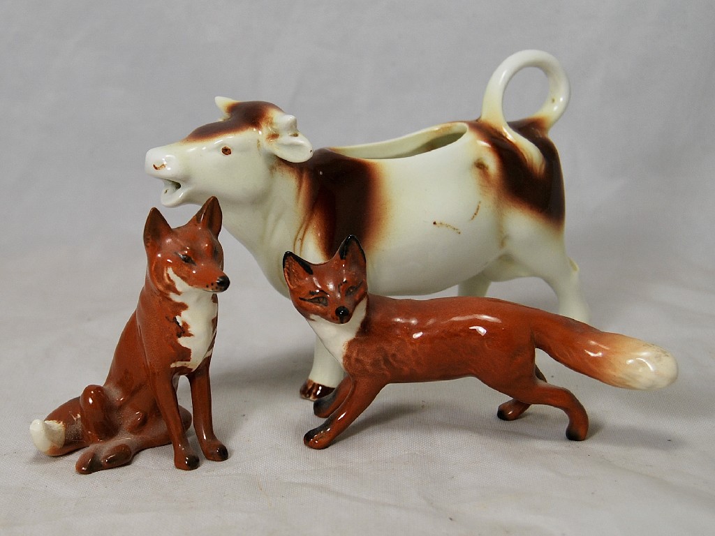 Appraisal: Two Beswick foxes and a Goebels cow creamer