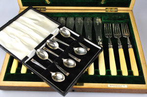 Appraisal: An Edwardian oak canteen containing six each silver fish knives