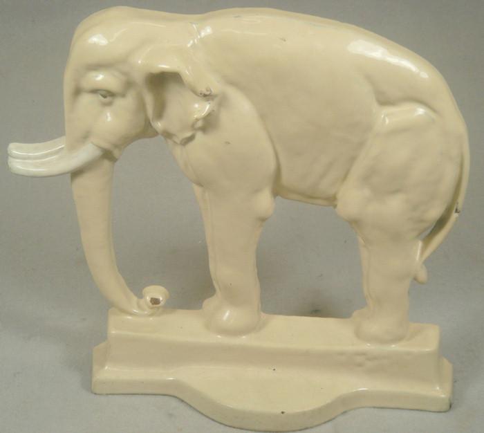 Appraisal: Cast iron doorstop large tan elephant on matching base light