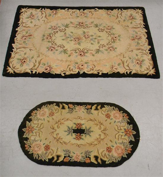 Appraisal: Two hooked rugs black border tan center floral motif '