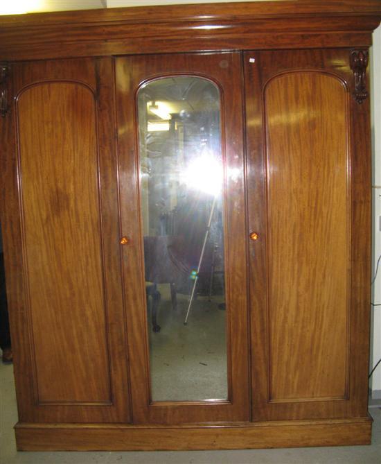 Appraisal: Victorian mahogany triple wardrobe the left-hand section with a single