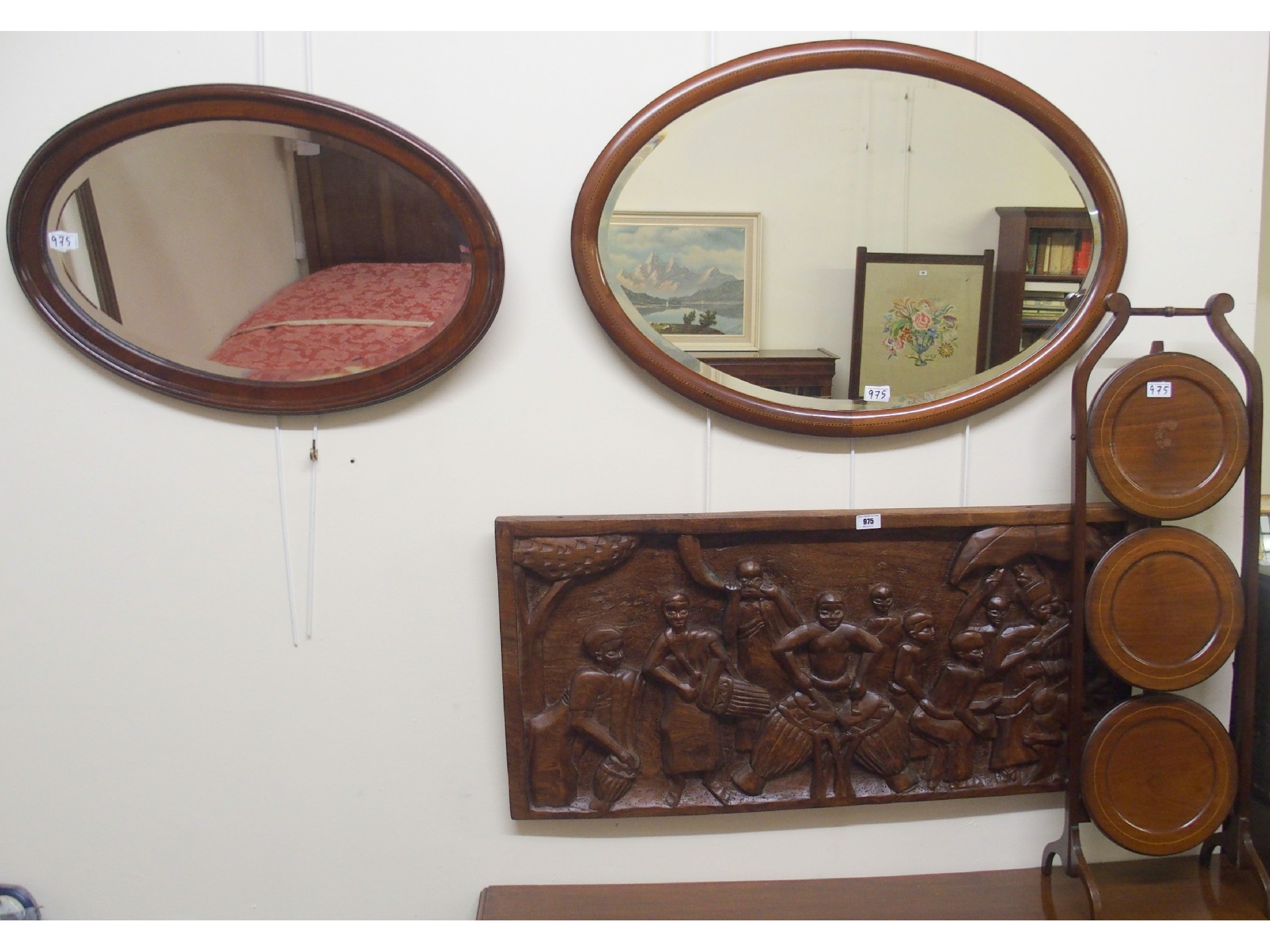 Appraisal: Two oval wall mirrors a carved hardwood plaque and a