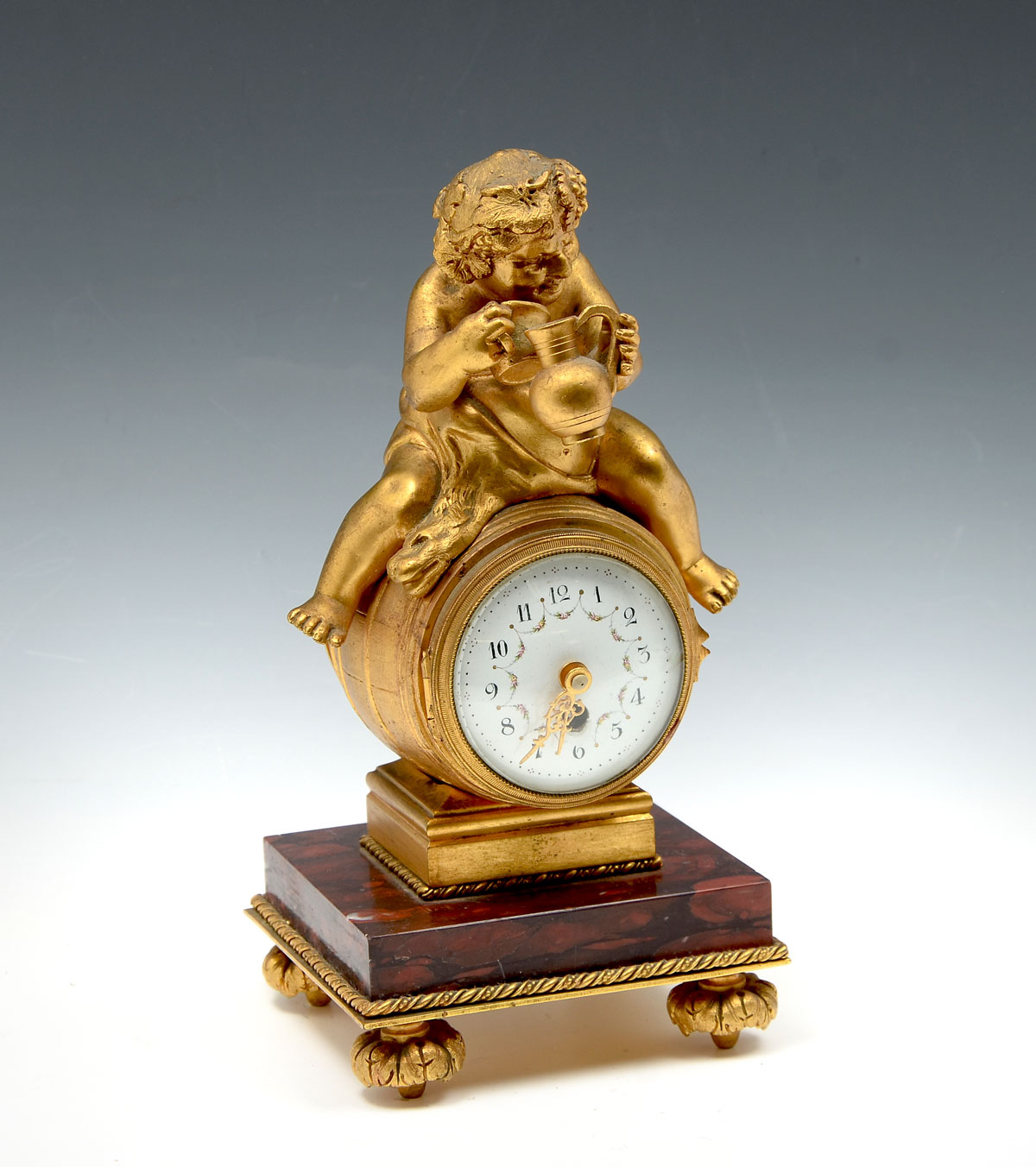 Appraisal: GILT MISCHIEVOUS CHERUB CLOCK th C Gilt clock having a