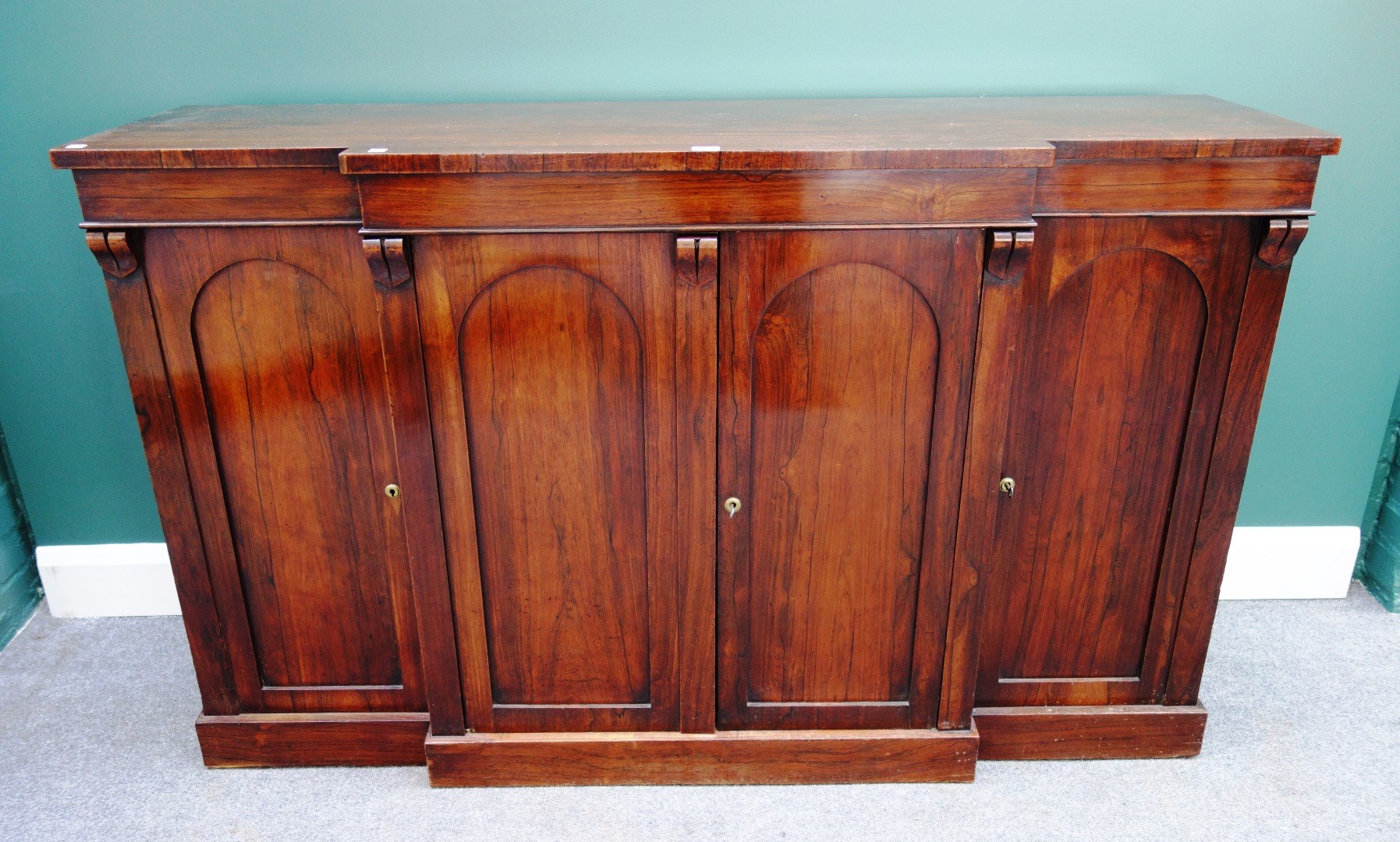 Appraisal: A mid th century rosewood breakfront side cabinet the four