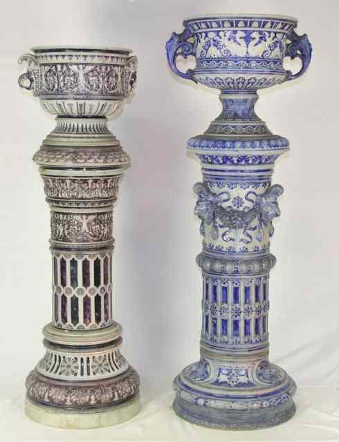 Appraisal: Two salt glazed stoneware two-handled urns on columns moulded and