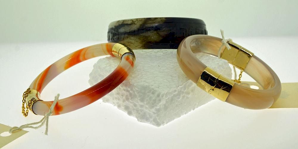 Appraisal: Three Bangles Three bangles one carved mottled jade two hardstone