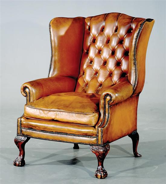 Appraisal: English carved mahogany and topnailed leather wing chair th century