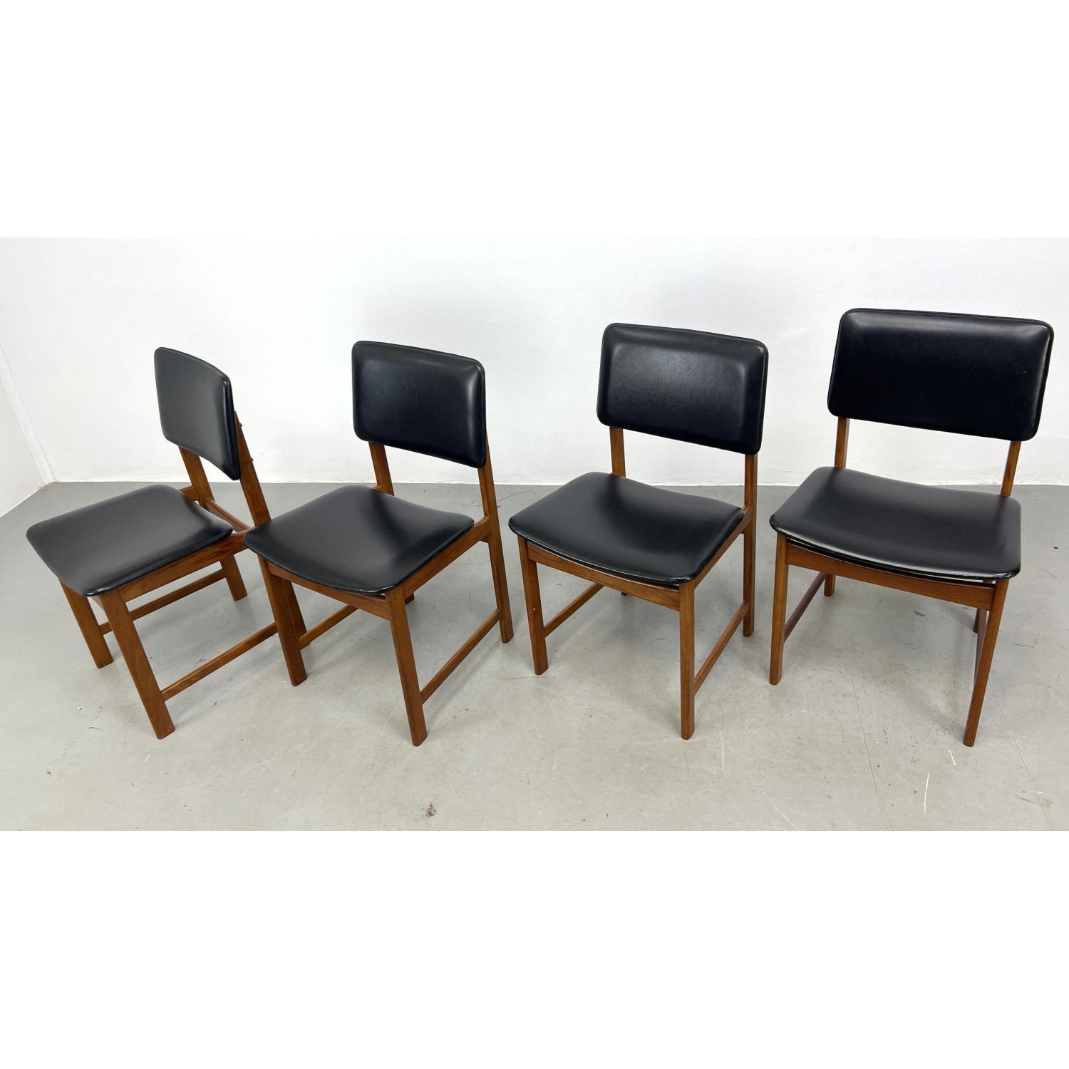 Appraisal: Set Danish Modern Teak Side Dining Chairs Black Vinyl upholstery