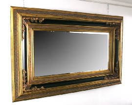 Appraisal: A Louis XV style ebonised and gilt framed wall mirror